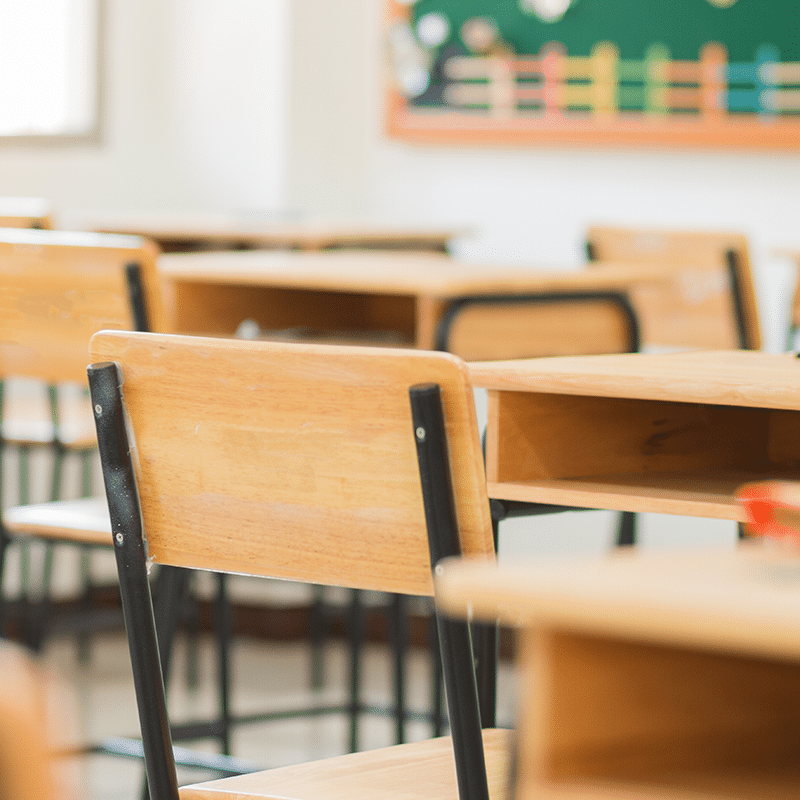 Travis AFB School Liaison Private School Info Image of a wooden desk and chair in a private school classroom